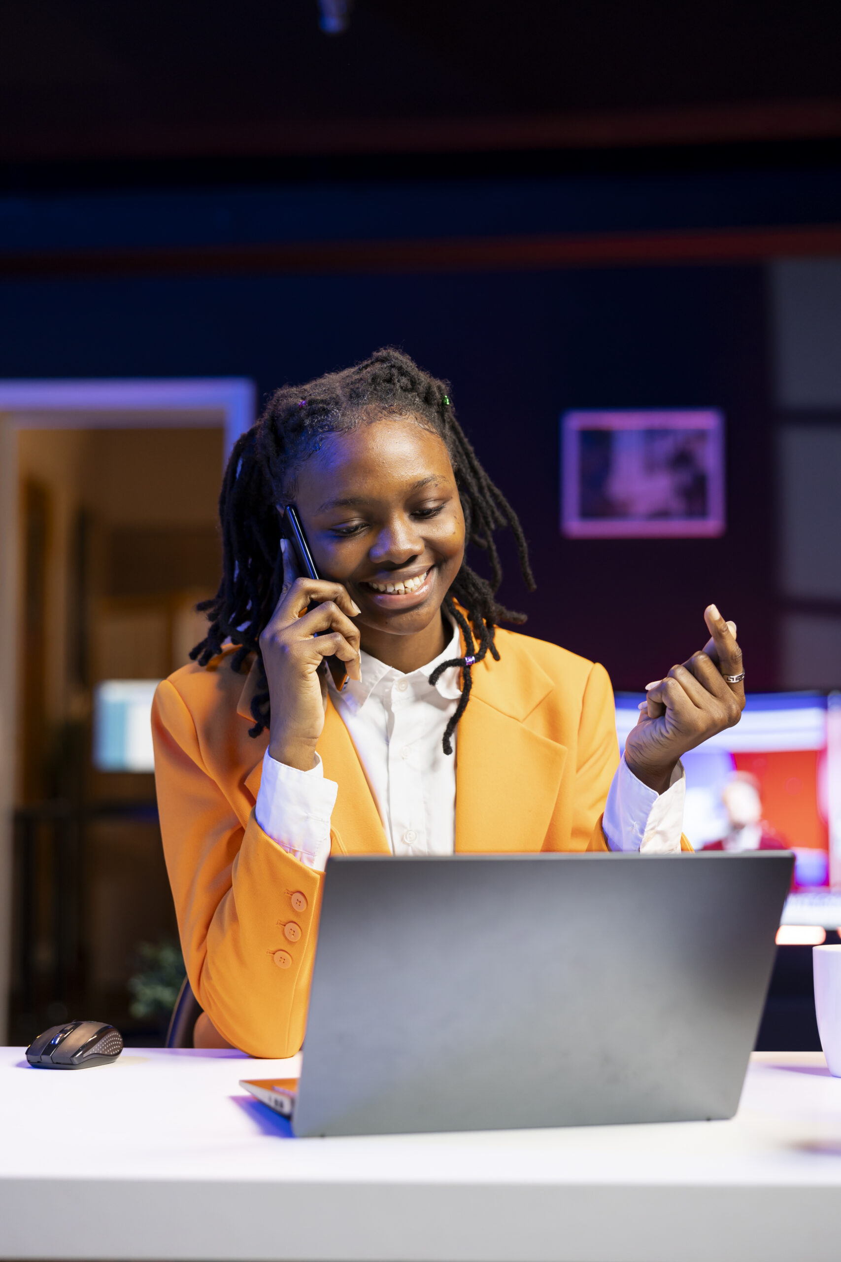 happy woman receiving pleasing phone call from friend while working from home